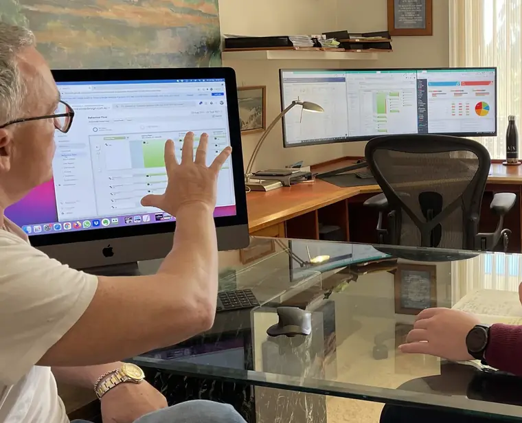Peter Brittain walking a team member through website analytics on screen